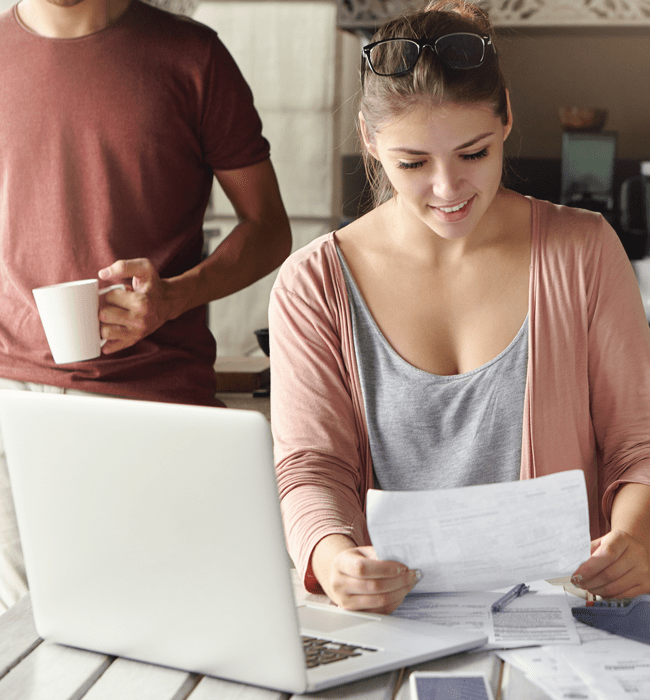 couple budgeting together with documents and Forecast Budgeting tool